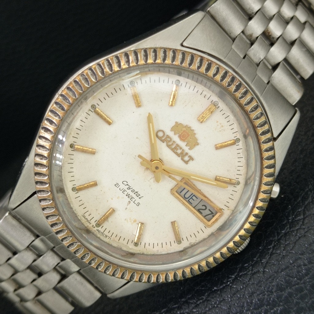 Vintage 1977 Orient Automatic Mens Silver Watch WDaydate Gold Accents Vintage 1977 Orient Automatic Mens Silver Watch WDaydate Gold Accents